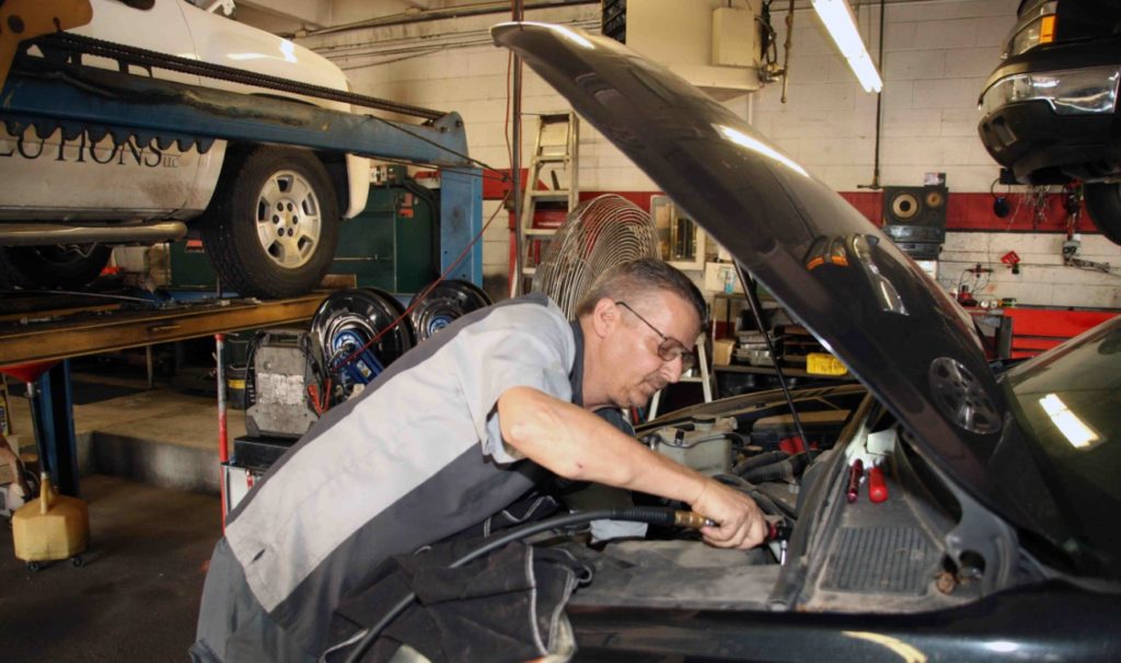 Photo of the Mastertech Transmission tech working under the hood of a car