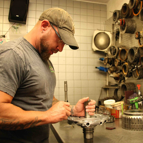 Photo of Josh Feiock, a transmission specialist, working on auto parts